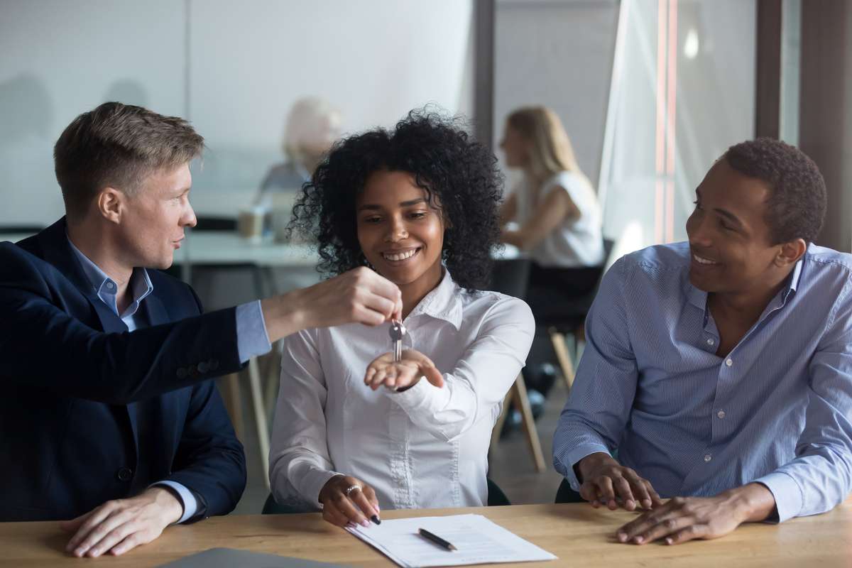 African American woman receiving keys from realtor, real estate deal (R) (S)