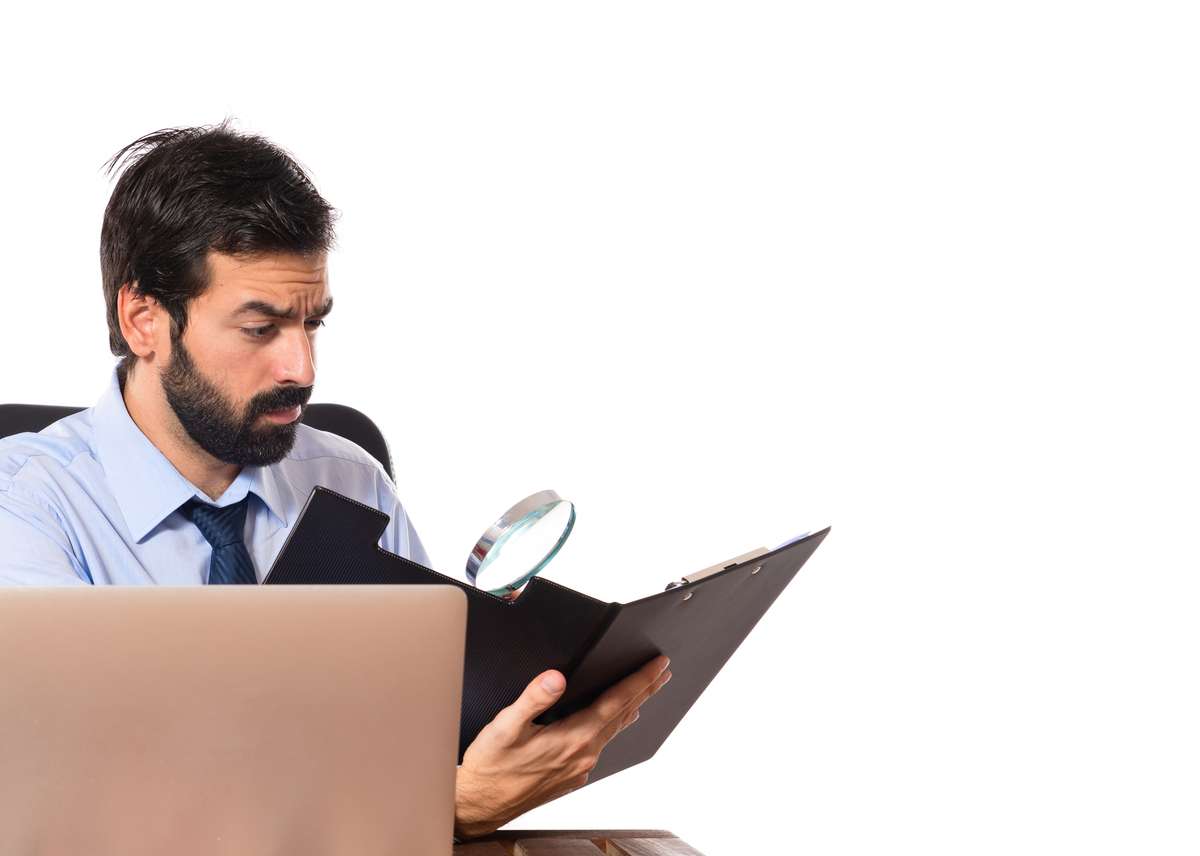 Businessman reading a book over white background (R) (S)