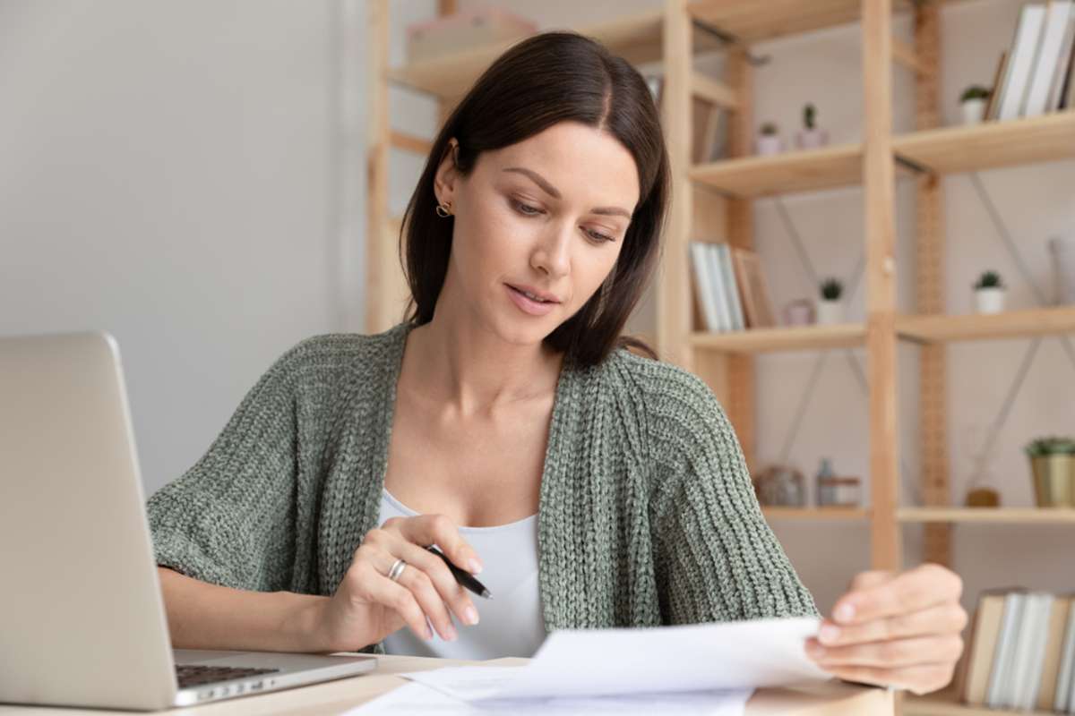 Close up focused young businesswoman working with documents in office