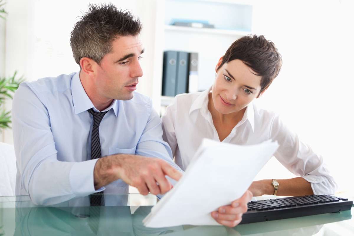 Colleagues reading documents in an office