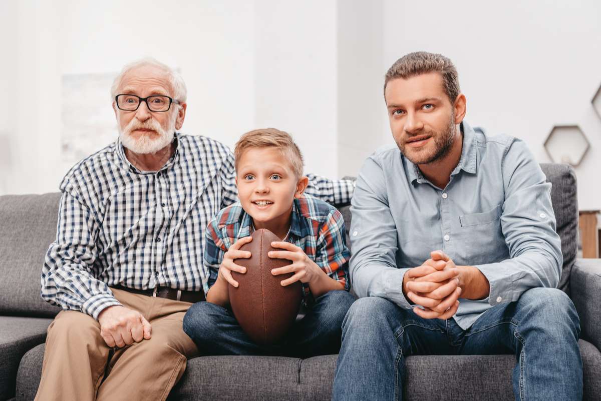 Family watching football at home (R) (S)