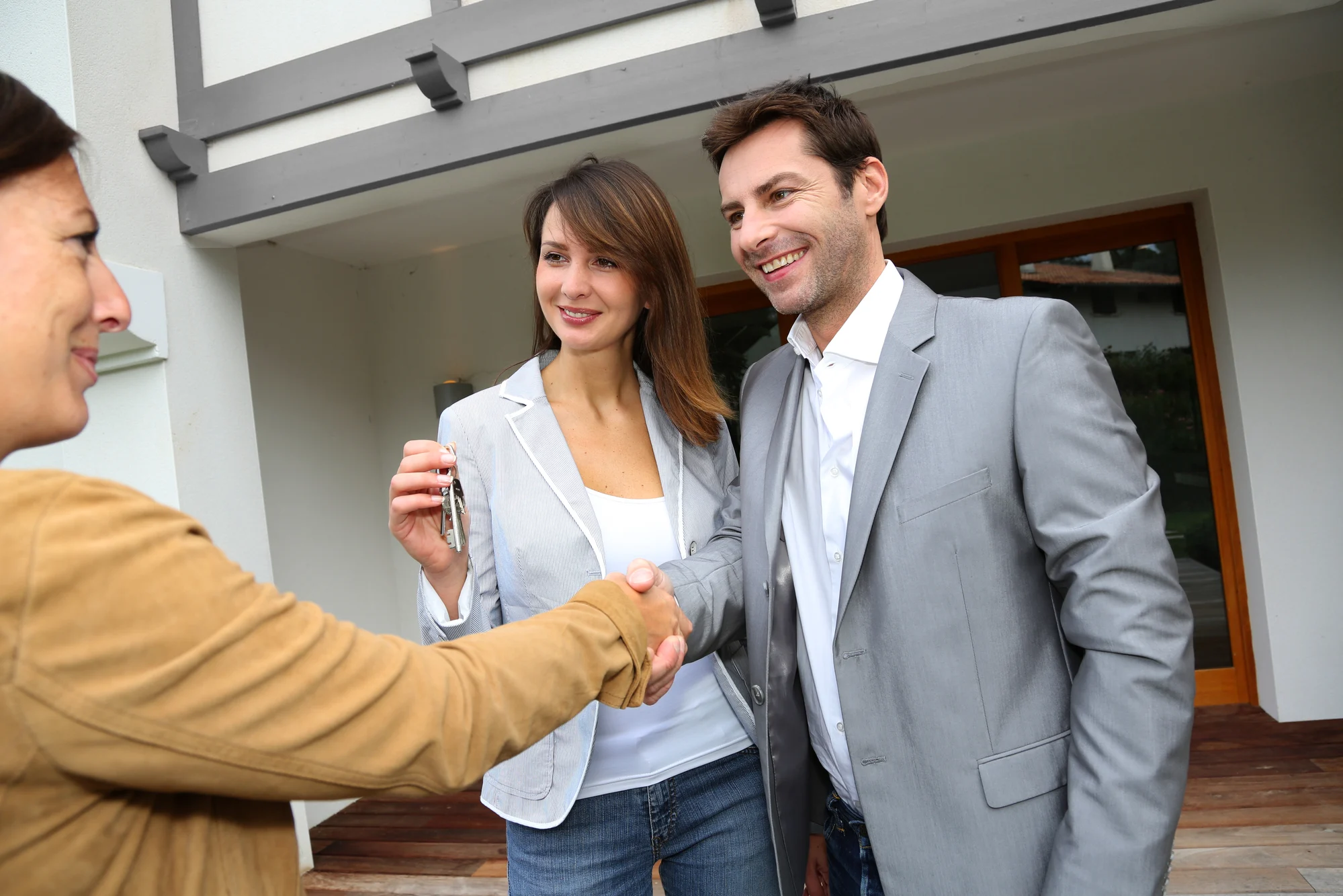 New property owners shaking hands to sales agent
